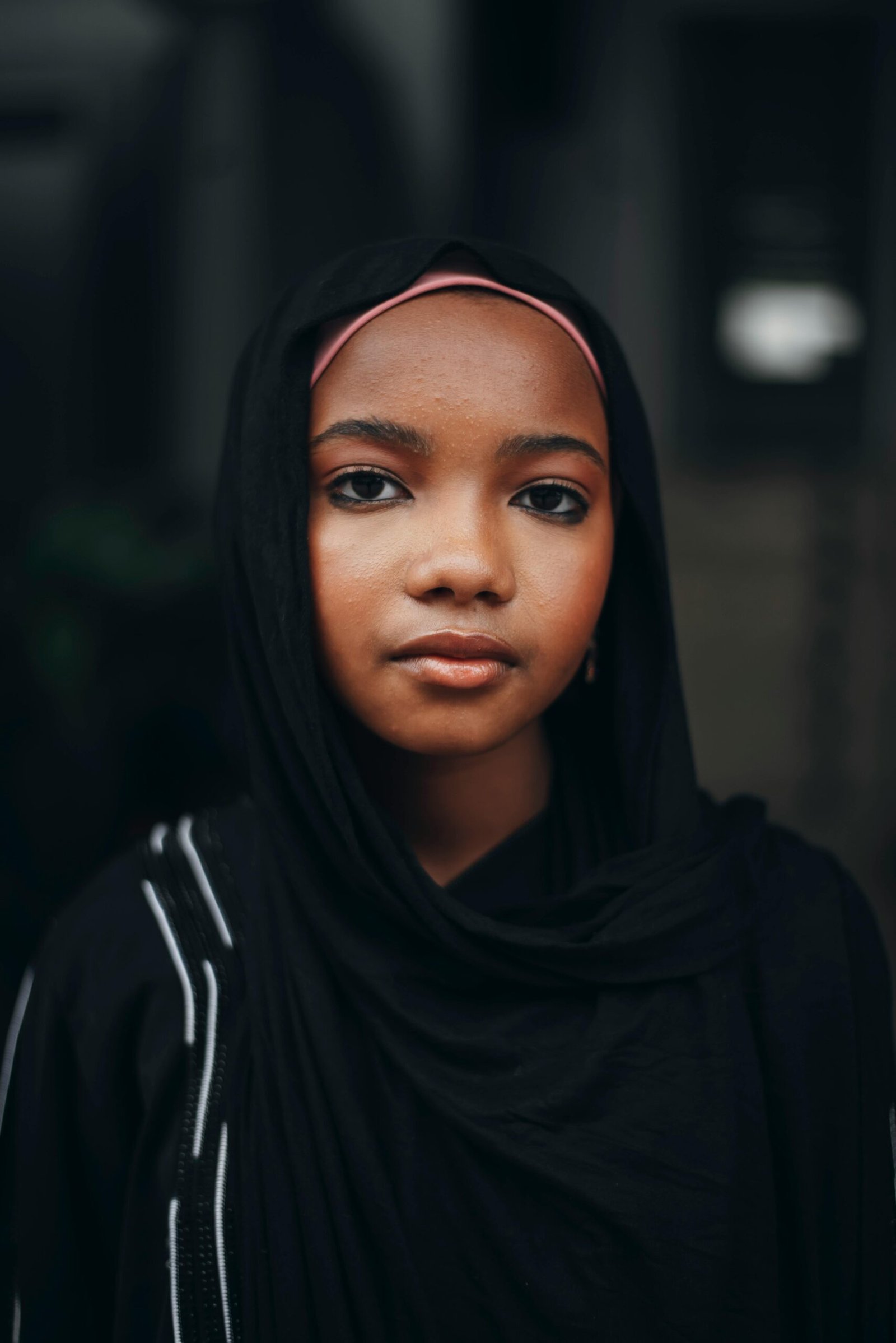 Portrait of a young Nigerian woman wearing a black hijab, reflecting cultural beauty.